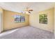 Empty bedroom with carpet flooring, two windows, and natural light at 5105 W Cleveland St, Tampa, FL 33609