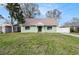 Charming, green single-story home featuring a well-maintained lawn and neutral-toned roof at 5105 W Cleveland St, Tampa, FL 33609