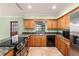Charming kitchen with granite countertops, stainless steel appliances, and wood cabinetry at 5105 W Cleveland St, Tampa, FL 33609