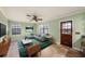 Inviting living room features neutral colors, a ceiling fan, and natural light from multiple windows at 5105 W Cleveland St, Tampa, FL 33609