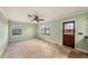 This is a bright living room with travertine tile floors and natural light coming in from two windows at 5105 W Cleveland St, Tampa, FL 33609