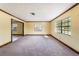 Spacious living room featuring neutral walls and carpets with large windows for ample light at 5105 W Cleveland St, Tampa, FL 33609