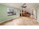 This living space includes a kitchen with wooden cabinets, a stainless-steel refrigerator, and a large window at 5105 W Cleveland St, Tampa, FL 33609