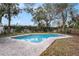 Inviting in-ground pool surrounded by a charming brick patio and lush landscaping at 5105 W Cleveland St, Tampa, FL 33609