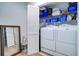 Laundry room with full sized washer and dryer and shelving with cleaning supplies at 5405 Bellefield Dr, Tampa, FL 33624