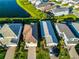 An aerial view of a home's roof, driveway and nearby homes, with manicured lawn at 5850 Silverside Pine Ct, Bradenton, FL 34211