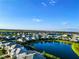 A beautiful aerial view of a housing community with a large pond and lush landscaping at 5850 Silverside Pine Ct, Bradenton, FL 34211