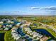 A panoramic aerial view of a community with ponds, golf courses, and roadways at 5850 Silverside Pine Ct, Bradenton, FL 34211