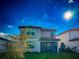 Back view of gray, two-story home, screened in patio, and a well-manicured lawn at 5850 Silverside Pine Ct, Bradenton, FL 34211