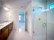 Modern bathroom with double sink vanity, framed mirrors, and a glass-enclosed shower at 5850 Silverside Pine Ct, Bradenton, FL 34211