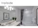 Modern bathroom with granite countertops, dual sinks, and a black and white checkered shower curtain at 5850 Silverside Pine Ct, Bradenton, FL 34211