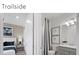 Cozy bathroom featuring grey vanity, white fixtures, framed art, and patterned shower curtain at 5850 Silverside Pine Ct, Bradenton, FL 34211