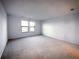 Bright bedroom with plush carpeting and large windows providing natural light at 5850 Silverside Pine Ct, Bradenton, FL 34211