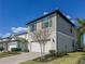 Beautiful two-story home with a gray exterior, white garage door, and well-maintained landscaping at 5850 Silverside Pine Ct, Bradenton, FL 34211