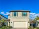 Inviting two-story home featuring a two-car garage, gray facade, and well-maintained landscaping at 5850 Silverside Pine Ct, Bradenton, FL 34211