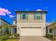 Charming two-story home featuring a symmetrical facade, two-car garage, and nicely landscaped front yard at 5850 Silverside Pine Ct, Bradenton, FL 34211