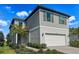 Charming two-story home with a gray exterior, two car garage, and well-manicured landscaping at 5850 Silverside Pine Ct, Bradenton, FL 34211