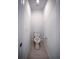 Compact half bathroom with an open toilet and neutral decor at 5850 Silverside Pine Ct, Bradenton, FL 34211