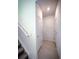 Hallway featuring neutral tile floors and white doors, connecting various spaces at 5850 Silverside Pine Ct, Bradenton, FL 34211