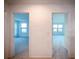 A hallway leads to two bedrooms with natural light streaming through the windows at 5850 Silverside Pine Ct, Bradenton, FL 34211