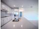 Bright kitchen boasts white cabinets, stainless appliances, large island with sink, and stylish finishes at 5850 Silverside Pine Ct, Bradenton, FL 34211