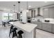 Modern kitchen featuring a large island, pendant lighting, stainless steel appliances, and stylish cabinetry at 5850 Silverside Pine Ct, Bradenton, FL 34211