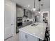 Contemporary kitchen featuring gray cabinets, stainless steel appliances, a quartz countertop island, and pendant lighting at 5850 Silverside Pine Ct, Bradenton, FL 34211