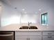 Kitchen island featuring a double sink with views of the living area and backyard at 5850 Silverside Pine Ct, Bradenton, FL 34211