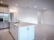 Open kitchen with an island, stainless steel appliances, and white cabinetry at 5850 Silverside Pine Ct, Bradenton, FL 34211
