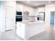 Bright kitchen features an island, stainless steel appliances, and white cabinetry at 5850 Silverside Pine Ct, Bradenton, FL 34211