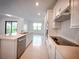 Modern kitchen featuring white cabinets, stainless steel appliances, and a large island perfect for entertaining at 5850 Silverside Pine Ct, Bradenton, FL 34211