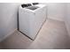 Laundry room features a modern washer and dryer set with tile flooring at 5850 Silverside Pine Ct, Bradenton, FL 34211