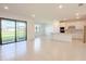 Open concept living area featuring tile floors, lots of light and access to the backyard through sliding glass doors at 5850 Silverside Pine Ct, Bradenton, FL 34211