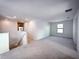 Spacious loft area with soft carpeting, bright natural light, and neutral wall paint at 5850 Silverside Pine Ct, Bradenton, FL 34211
