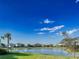 Beautiful pond view with lush grass and neighborhood homes in the background at 5850 Silverside Pine Ct, Bradenton, FL 34211