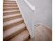 A carpeted staircase with white railings leads to the upper level of the house at 5850 Silverside Pine Ct, Bradenton, FL 34211