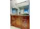 Bathroom featuring a granite vanity top and dark wooden cabinets and drawers at 660 Island Way # 202, Clearwater Beach, FL 33767