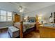 Comfortable bedroom featuring a bed, wooden dresser, hardwood floors, and natural light at 660 Island Way # 202, Clearwater Beach, FL 33767
