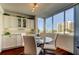 Charming breakfast nook with window views, white cabinetry, and a modern glass table at 660 Island Way # 202, Clearwater Beach, FL 33767