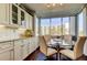 Inviting breakfast nook featuring full windows and custom cabinetry with granite countertops at 660 Island Way # 202, Clearwater Beach, FL 33767