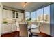 Bright dining area with floor to ceiling windows, modern light fixture, and stylish furnishings at 660 Island Way # 202, Clearwater Beach, FL 33767