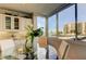 Bright dining area with floor to ceiling windows, modern light fixture, and stylish furnishings at 660 Island Way # 202, Clearwater Beach, FL 33767