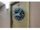 A charming front door decorated with a beach-themed wreath and a welcoming sign at 660 Island Way # 202, Clearwater Beach, FL 33767