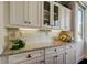 Kitchen features custom cabinetry, granite countertops, and backsplash lighting at 660 Island Way # 202, Clearwater Beach, FL 33767