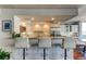 Open kitchen with stainless steel appliances, white cabinets and breakfast bar at 660 Island Way # 202, Clearwater Beach, FL 33767