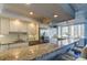 Well-lit kitchen featuring granite countertops, stainless steel appliances, and breakfast bar at 660 Island Way # 202, Clearwater Beach, FL 33767