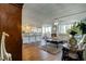 Open living area with a bar kitchen, hardwood floors, and bright natural light at 660 Island Way # 202, Clearwater Beach, FL 33767