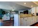 Open living space with white furniture, wood floors, and decor viewed from kitchen counter at 660 Island Way # 202, Clearwater Beach, FL 33767