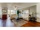 Open concept living room with hardwood floors and large windows overlooking palm trees at 660 Island Way # 202, Clearwater Beach, FL 33767