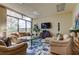 Cozy living room with a large window, comfortable seating and a modern entertainment center at 660 Island Way # 202, Clearwater Beach, FL 33767